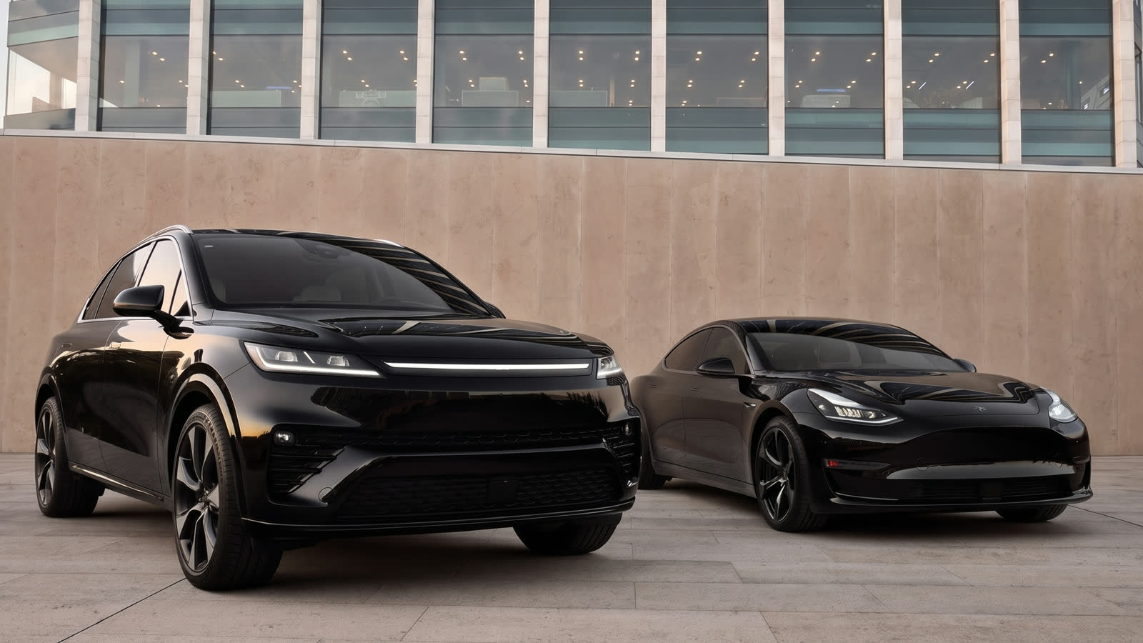 Two black luxury vehicles staged at a corporate building at dusk